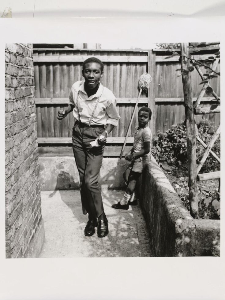 Untitled [Young teenage boy who, just arrived from Jamaica, shows off his latest reggae dance with his younger brother watching, Brixton Hill] top image