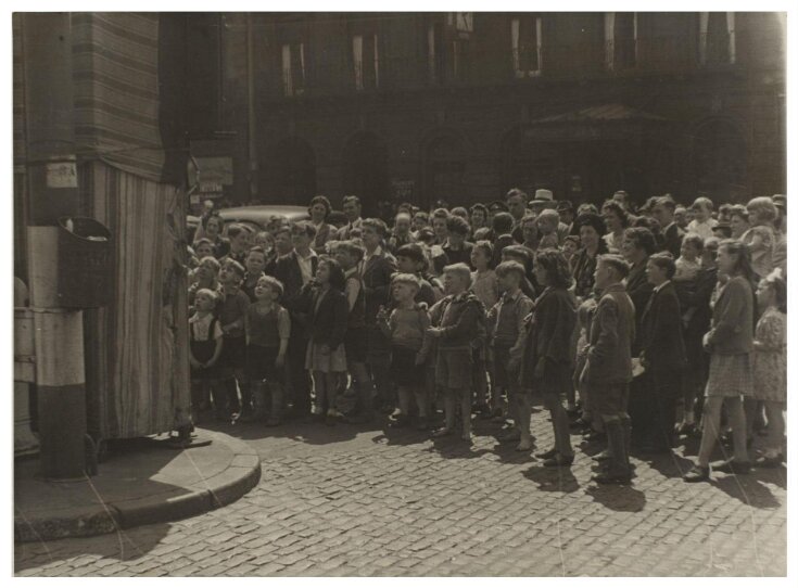 The audience at Professor Richard Codman lll's Punch and Judy booth, Liverpool, ca.1940 top image