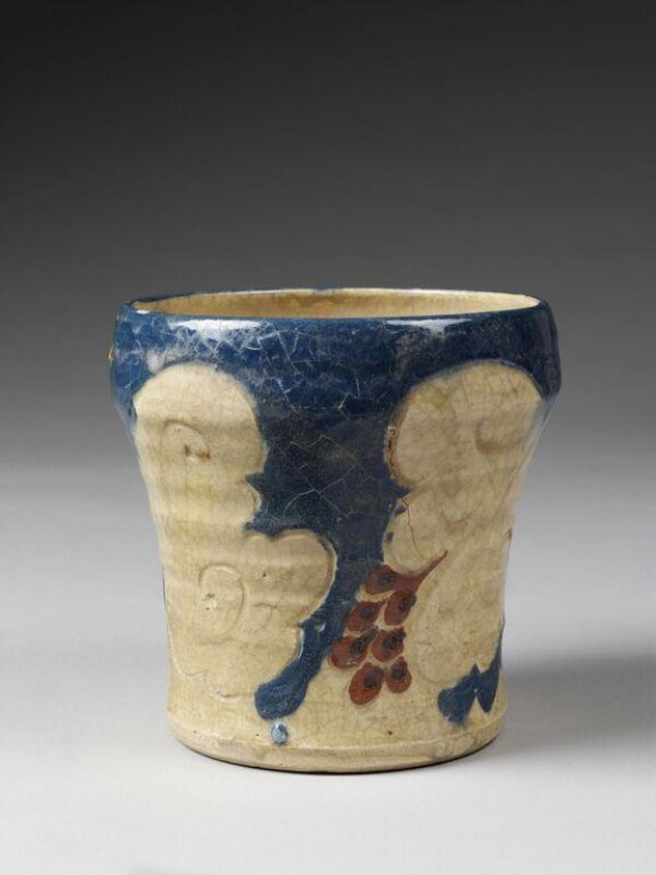 Bernard Leach’s 1913 Tokyo raku vase, with cream vine leaves, blue ground, red grapes and visible crazing
