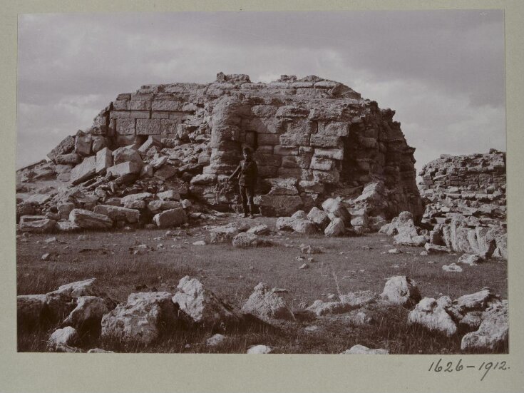 Photograph of a a ruined temple with a Turkish soldier in the Great Iwan at Hatra, Iraq top image