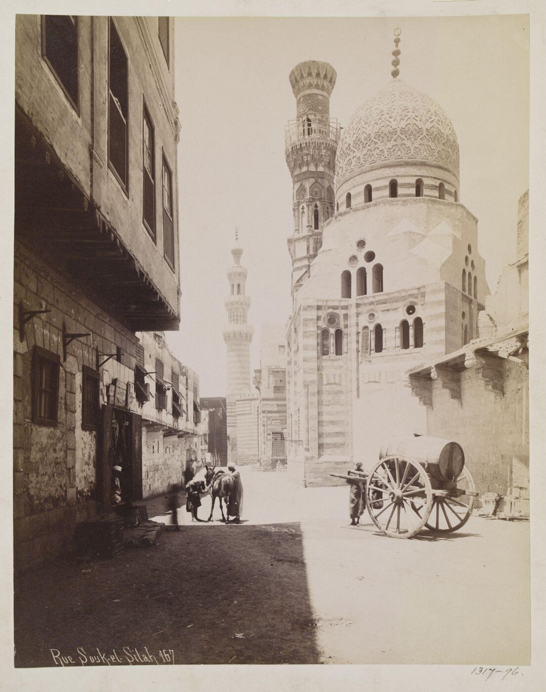 Jean Pascal Sebah, Bab al-Wazir street with the funerary madrasa of Amir Khayrbak and the mosque of Amir Aqsunqur (Blue mosque), Cairo
