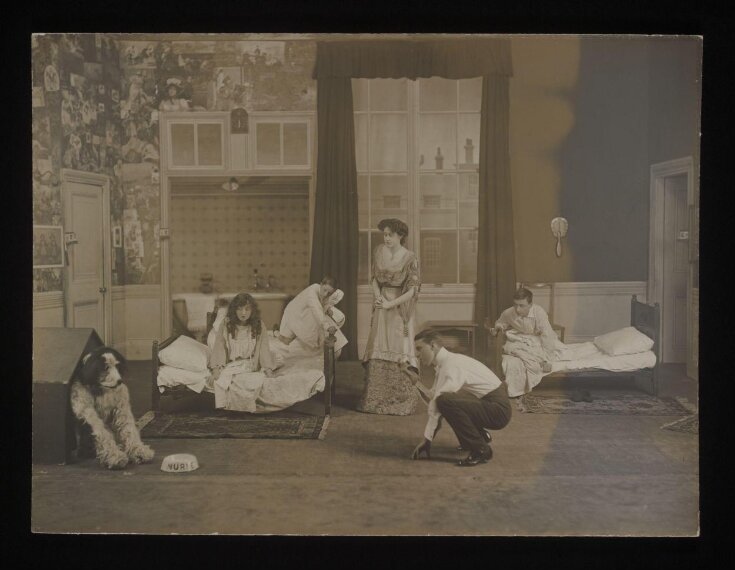 Pauline Chase as Peter Pan, Hilda Trevelyan as Wendy, George Hersee as John, and Herbert Hollom as Michael in the nursery scene from Peter Pan, Duke of York's Theatre, December 1907 top image