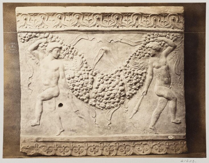 Bas-relief of portion of frieze of dancing figures with torches bearing festoon of fruit in terra cotta top image
