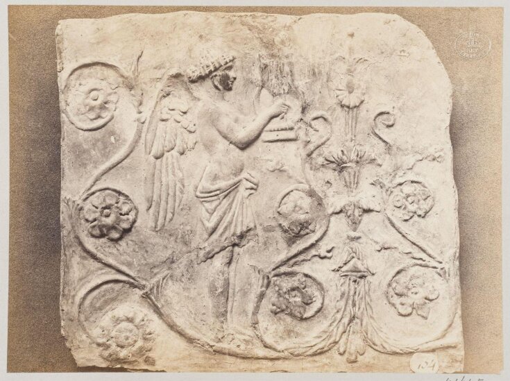 Bas-relief of a geni and a lyre in terra cotta top image