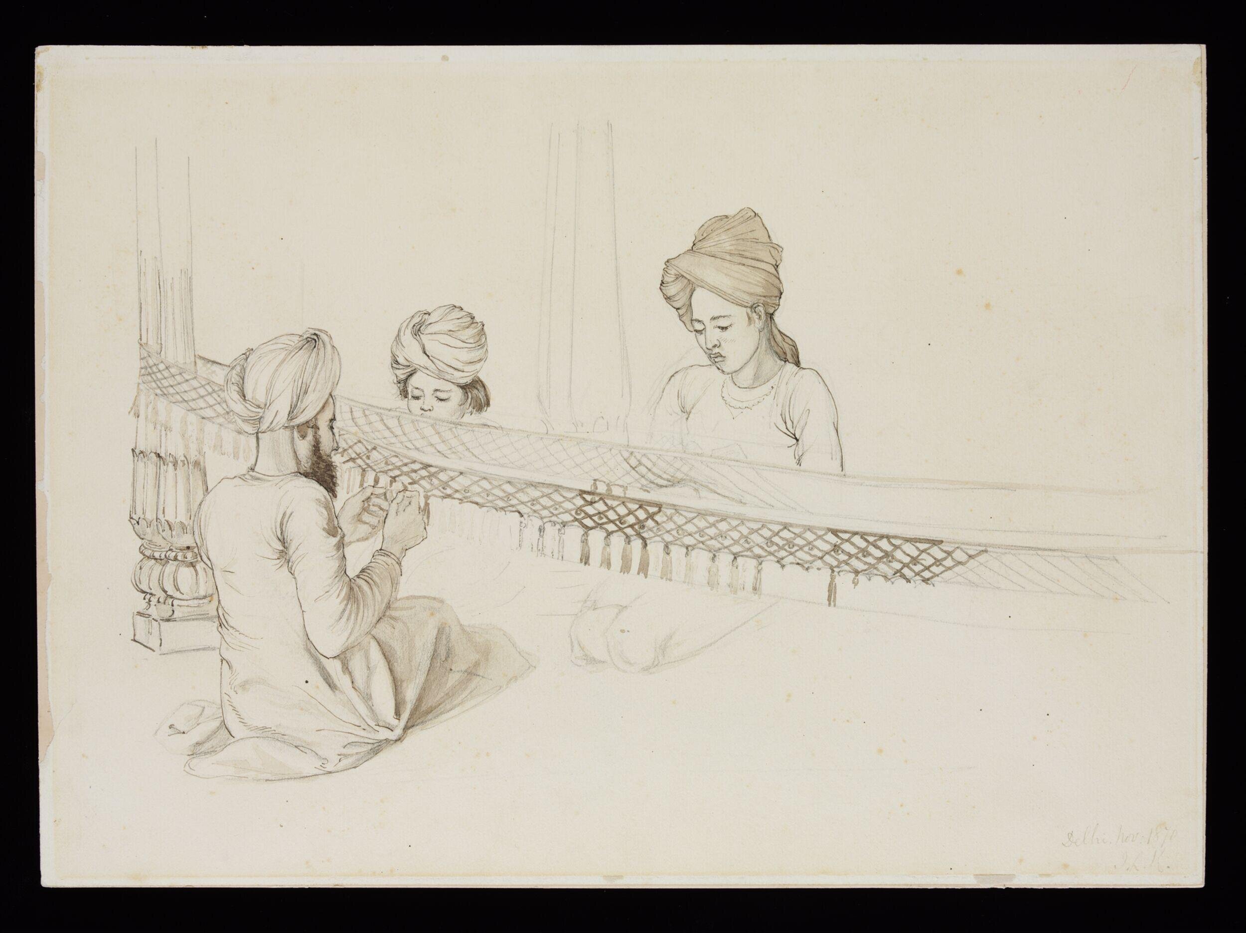 Three boys making a fringe for an elephant decoration