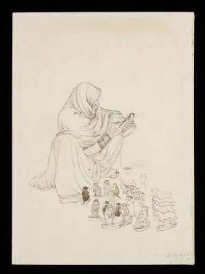 A seated woman painting spots on a toy leopard