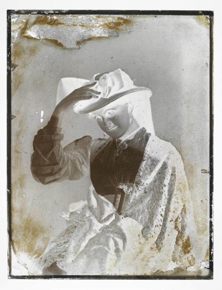 Lady Seated Holding Hat to her Head top image