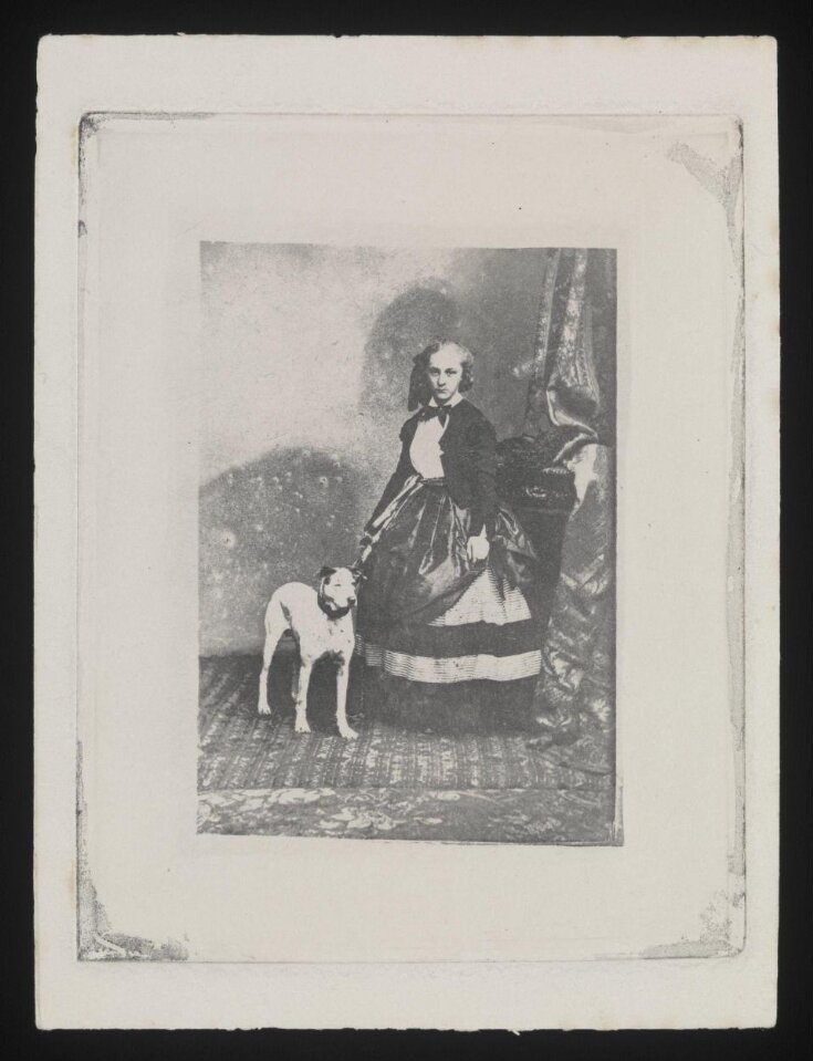 Studio portrait of a woman standing with a white dog top image