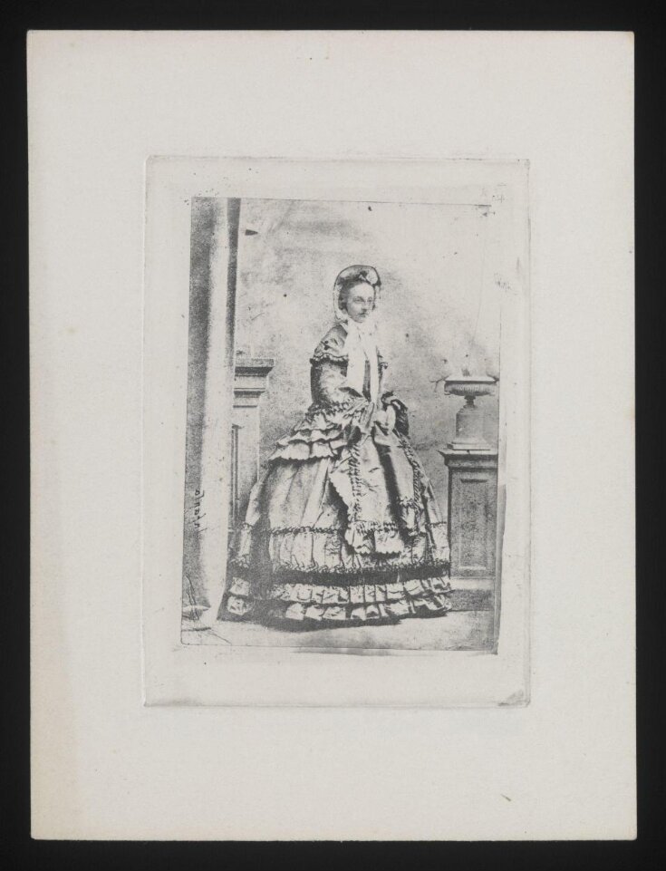 Studio portrait of a standing woman top image