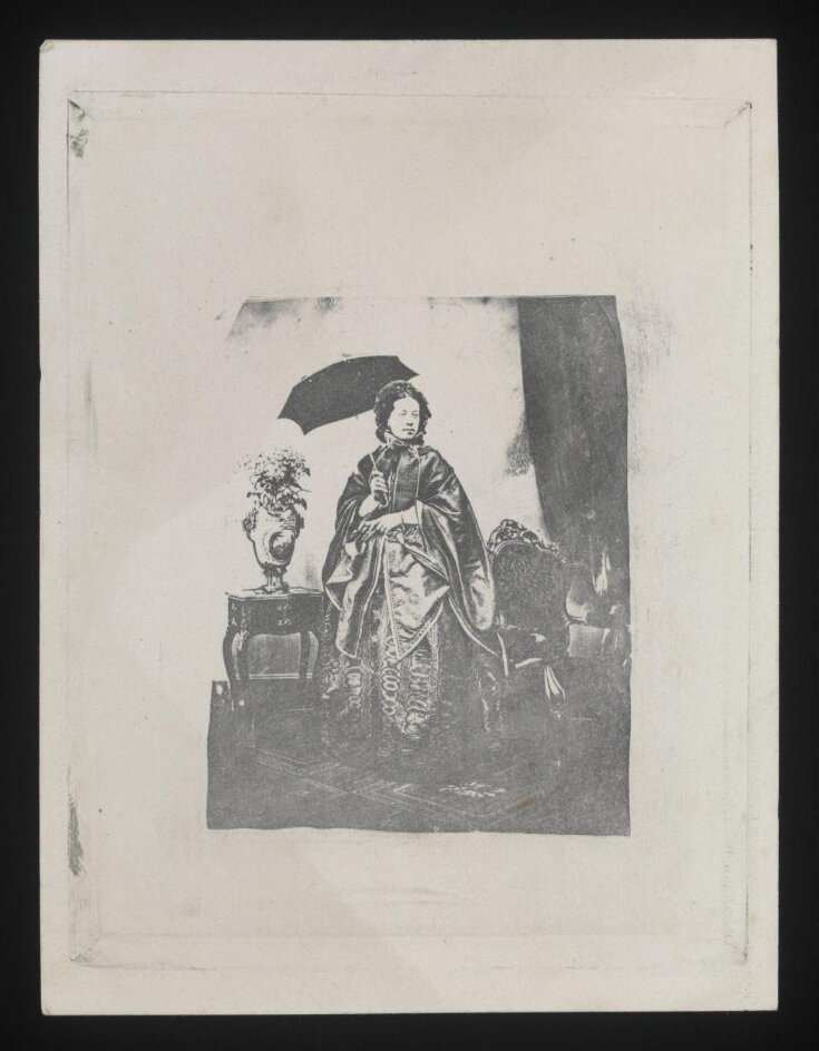 Studio portrait of a woman standing with a black parasol top image