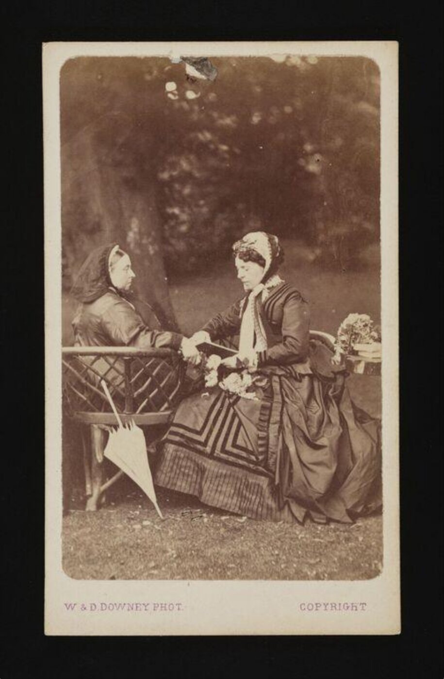 W. & D. Downey, Queen Victoria sitting in a chair, in a garden