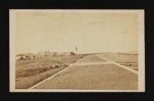 A photograph of a beach with buildings thumbnail 1