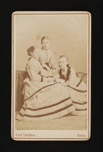 A photograph of three young girls