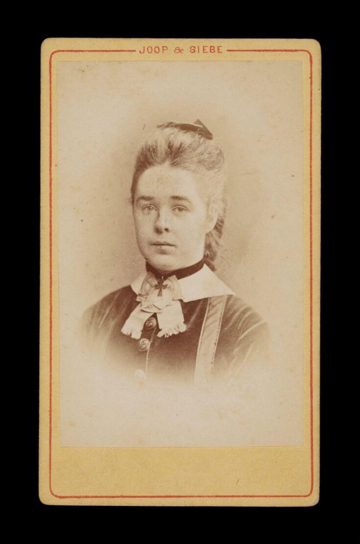 A portrait of a young woman top image