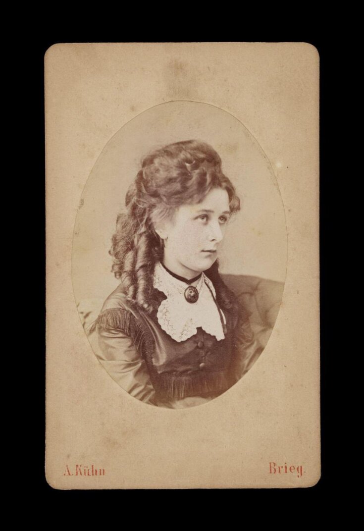 A portrait of a young woman top image