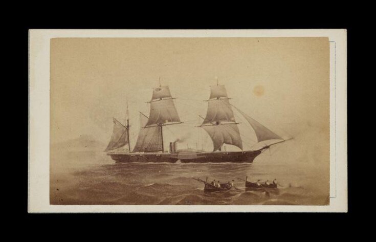 ship at sea with two rowboats in the foreground image