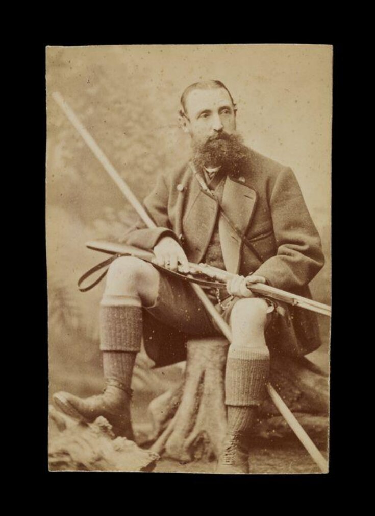 image of gentleman holding a rifle image