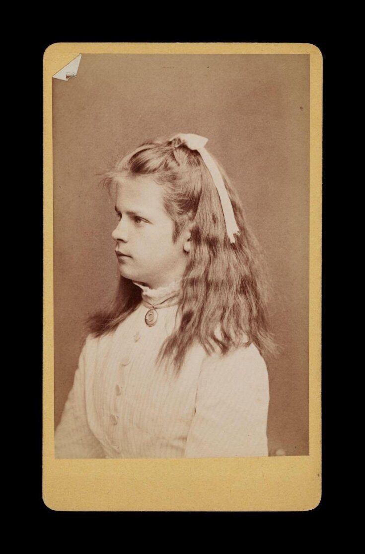 Side profile portrait of a young woman with a bow in her hair image