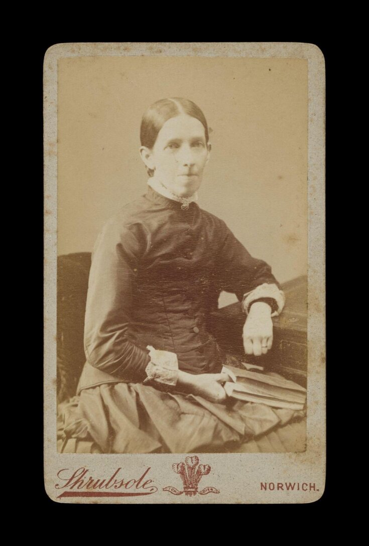 Portrait of a woman seated holding a book image