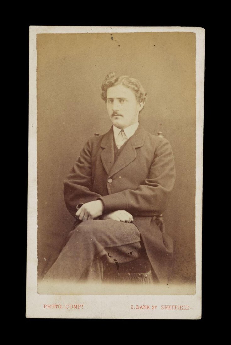 portrait of a man sat in a chair image