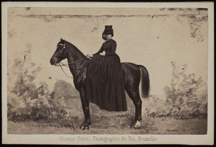 A photograph of a woman on a horse image