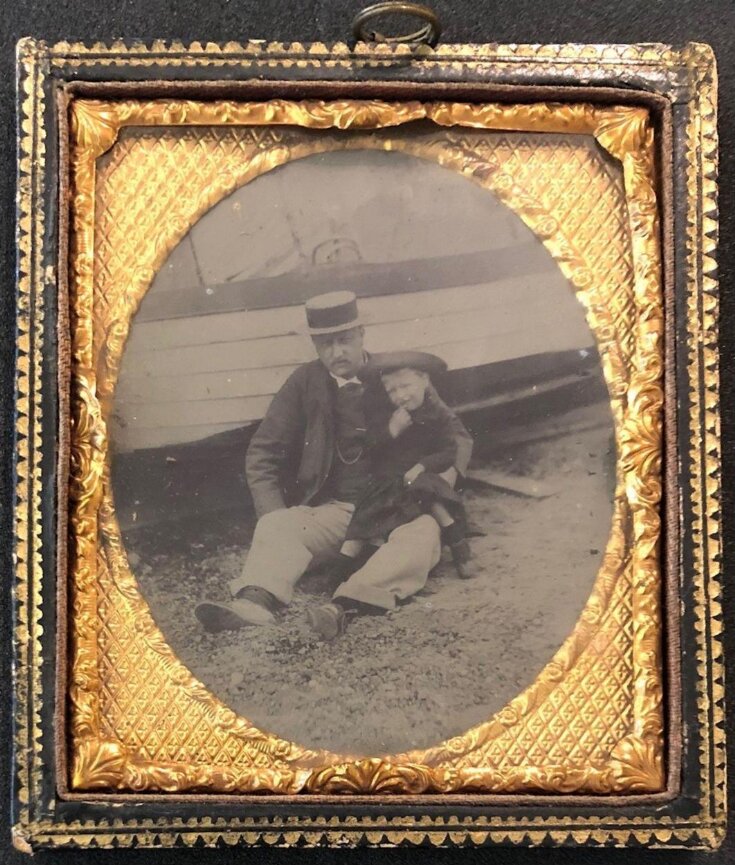 Man and child at the beach top image