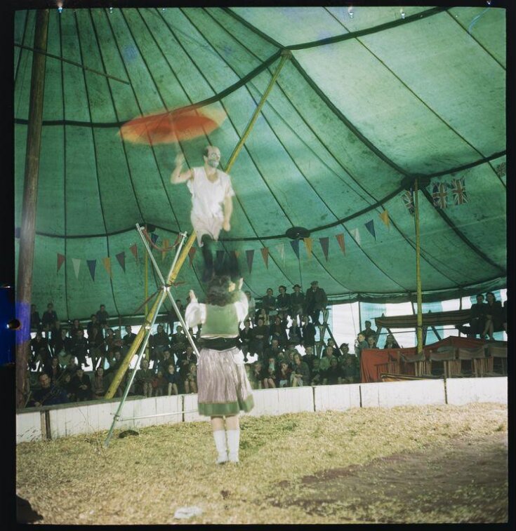 Clown performing on a tightrope top image