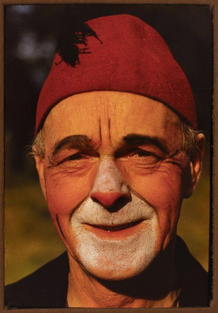 portrait of a clown wearing a fez hat top image