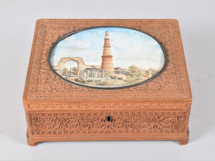 An oblong sandalwood box carved with a flower pattern in low relief, with an ivory miniature of the Qutb Minar, Delhi, on the lid. top image