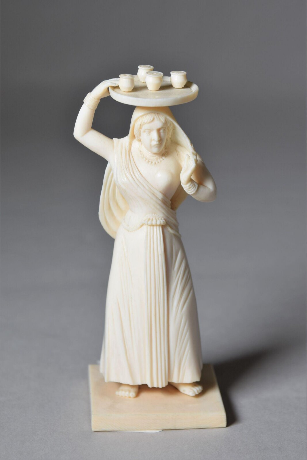 Woman carrying tray, 19th Century