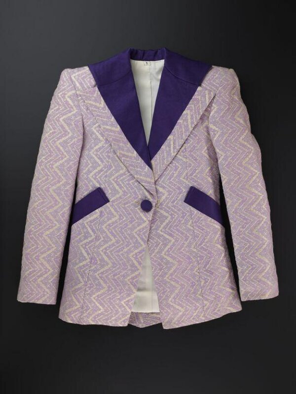 A mauve and silver zig-zag jacket with purple peak lapels and squared shoulders