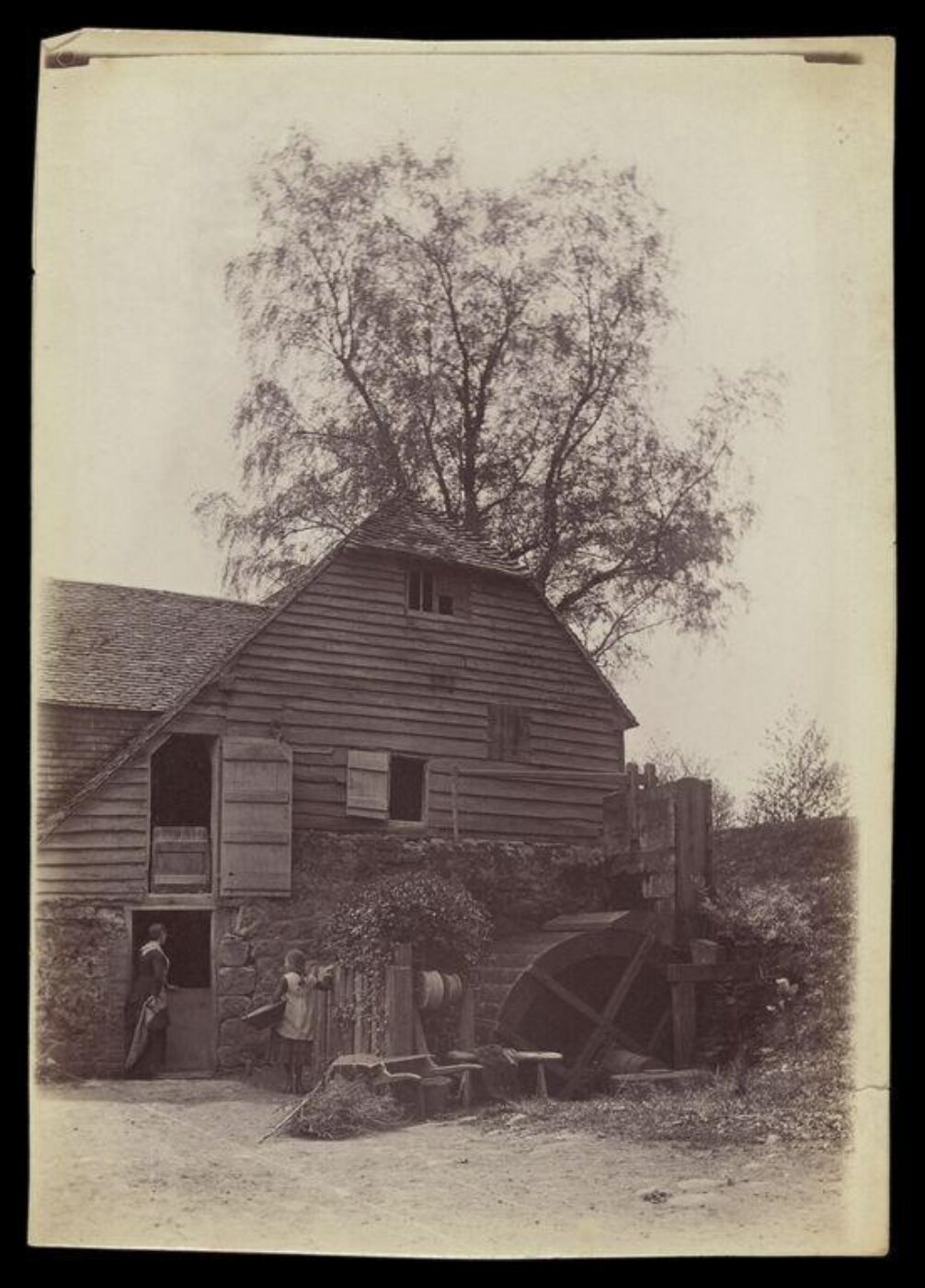 Gale, Lt. Col. Joseph, Woman and girl outside house with water wheel