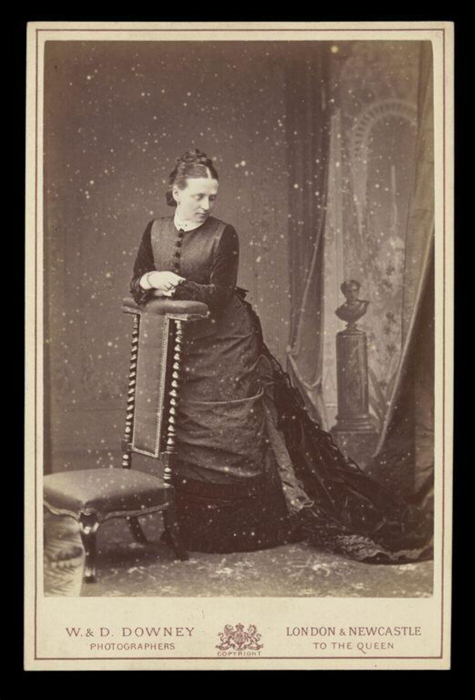 W. & D. Downey, Portrait of a woman resting against a chair